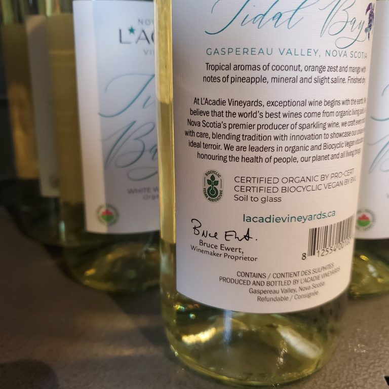 Tidal Bay from L'Acadie Vineyards in Gaspereau Nova Scotia. Organic wine and Biocyclic V Vegan wine certification logos.